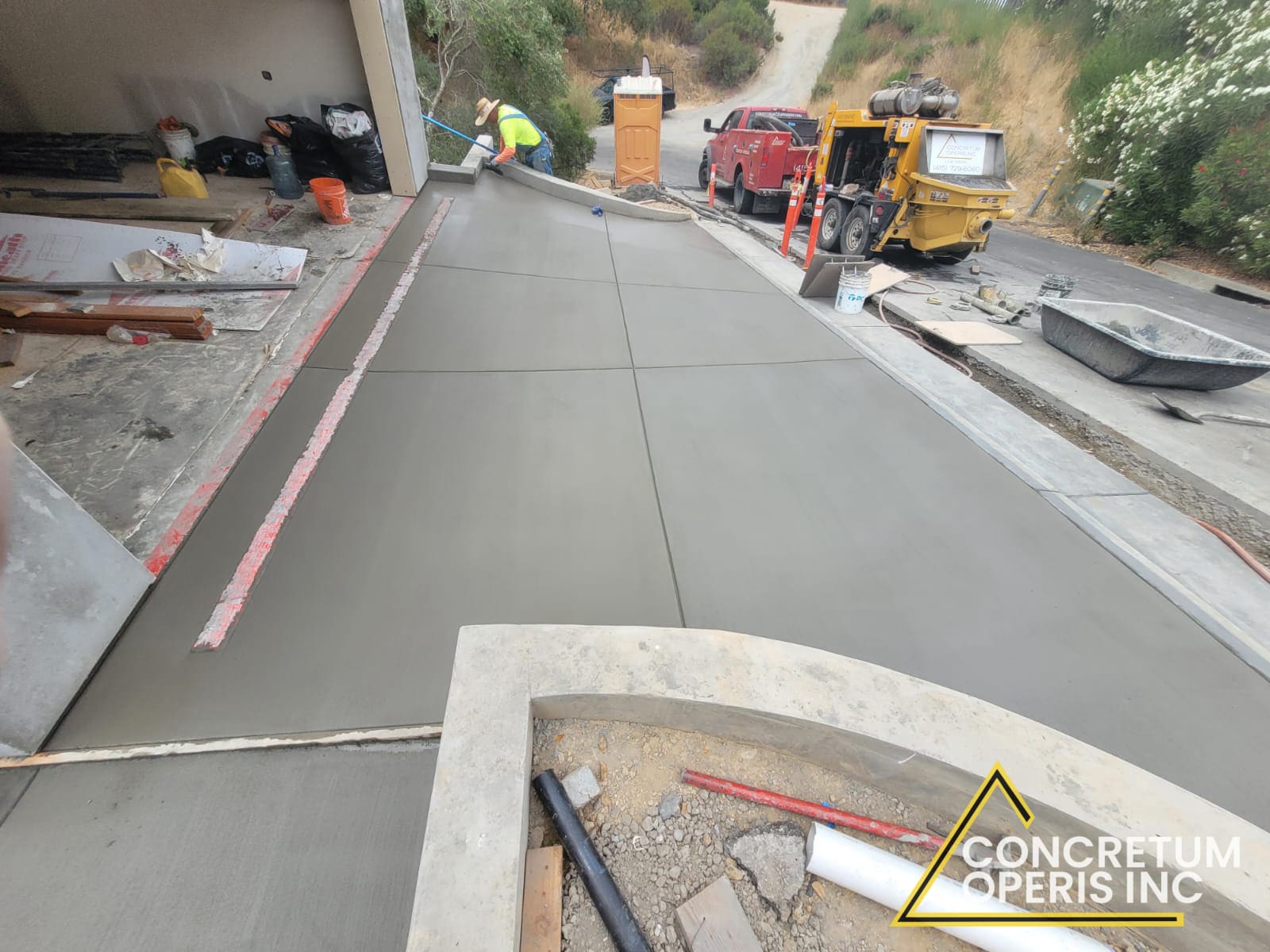 Freshly poured concrete driveway leading to a hillside garage in San Rafael, CA