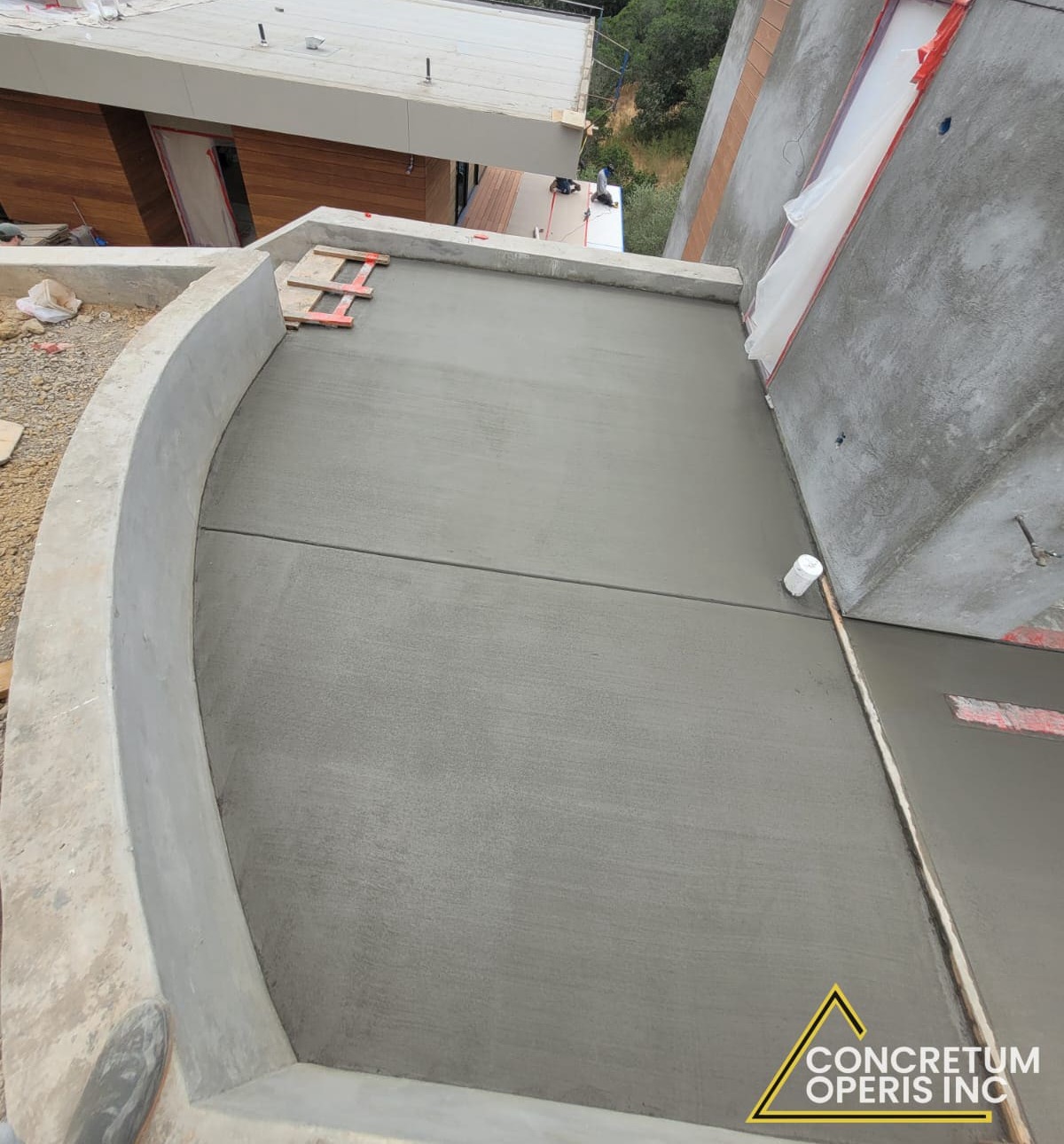 Freshly poured concrete terrace deck beside a facade wall with taped waterproofing joints in San Rafael, CA