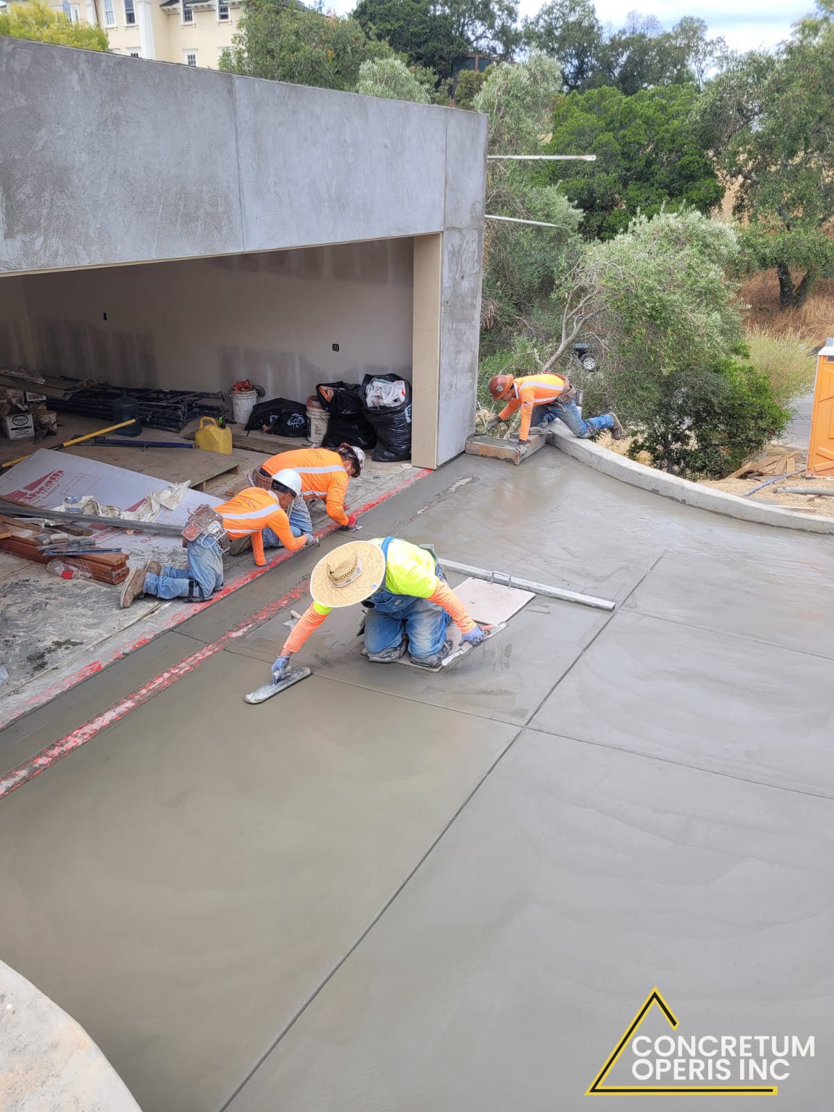 Crew finishing a concrete surface on a hillside facade project in San Rafael, CA