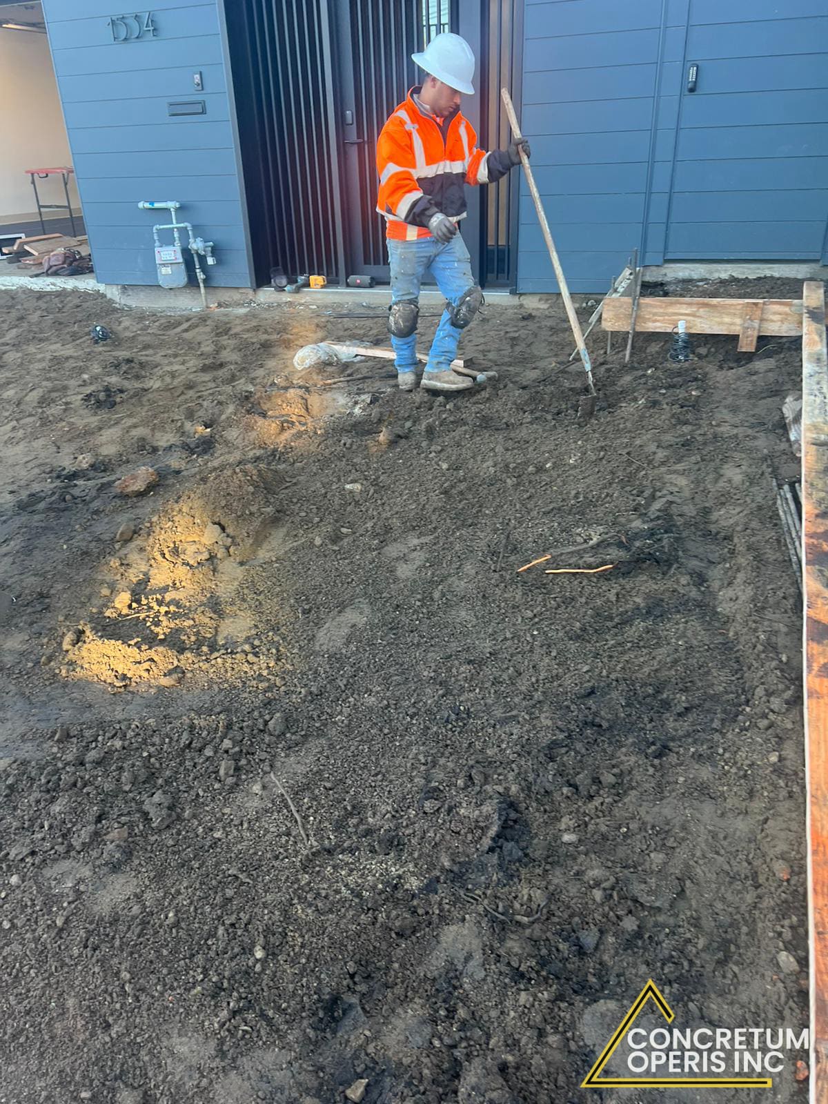 Crew pouring and screeding fresh concrete for a driveway slab in San Francisco, CA
