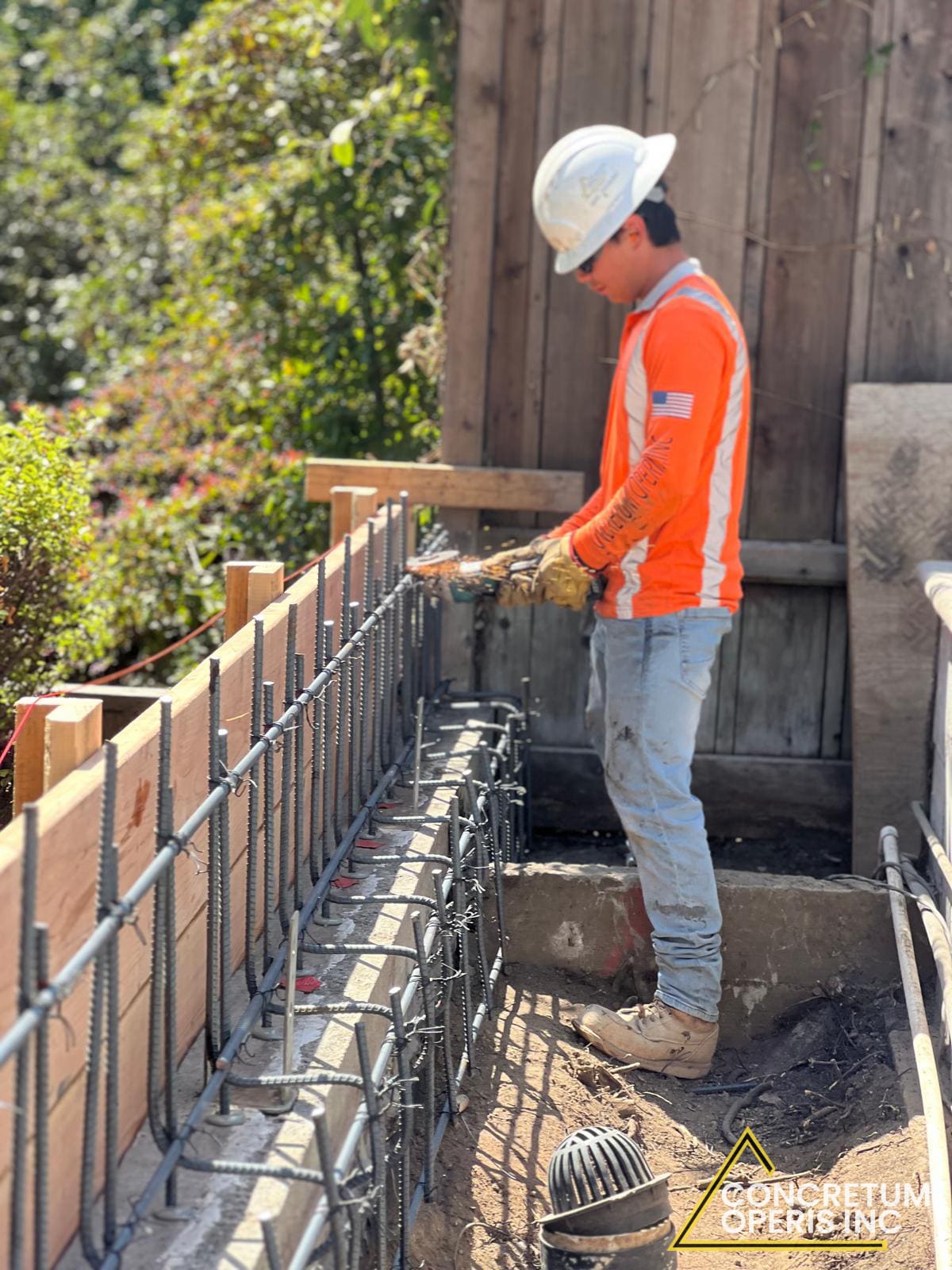 Rebar and formwork set along a foundation wall for a pool deck project in Richmond, CA