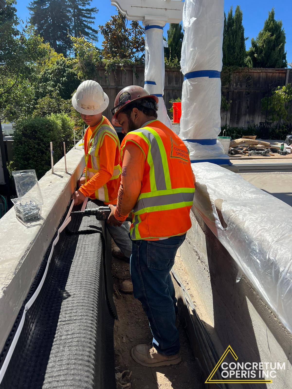 Concrete crew setting formwork along the pergola footing in Richmond, CA