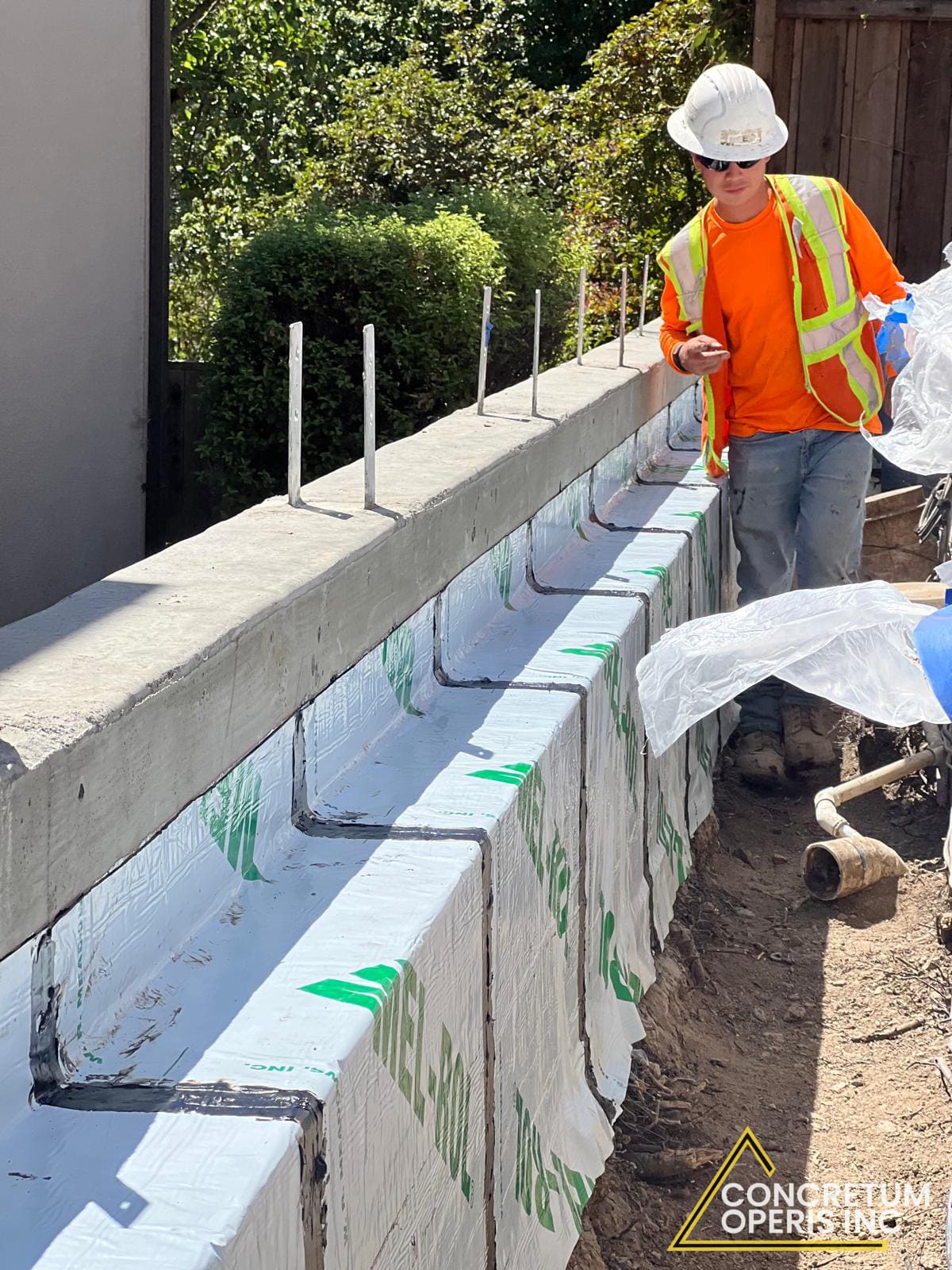 Waterproofing membrane applied to a formed concrete foundation wall in Richmond, CA