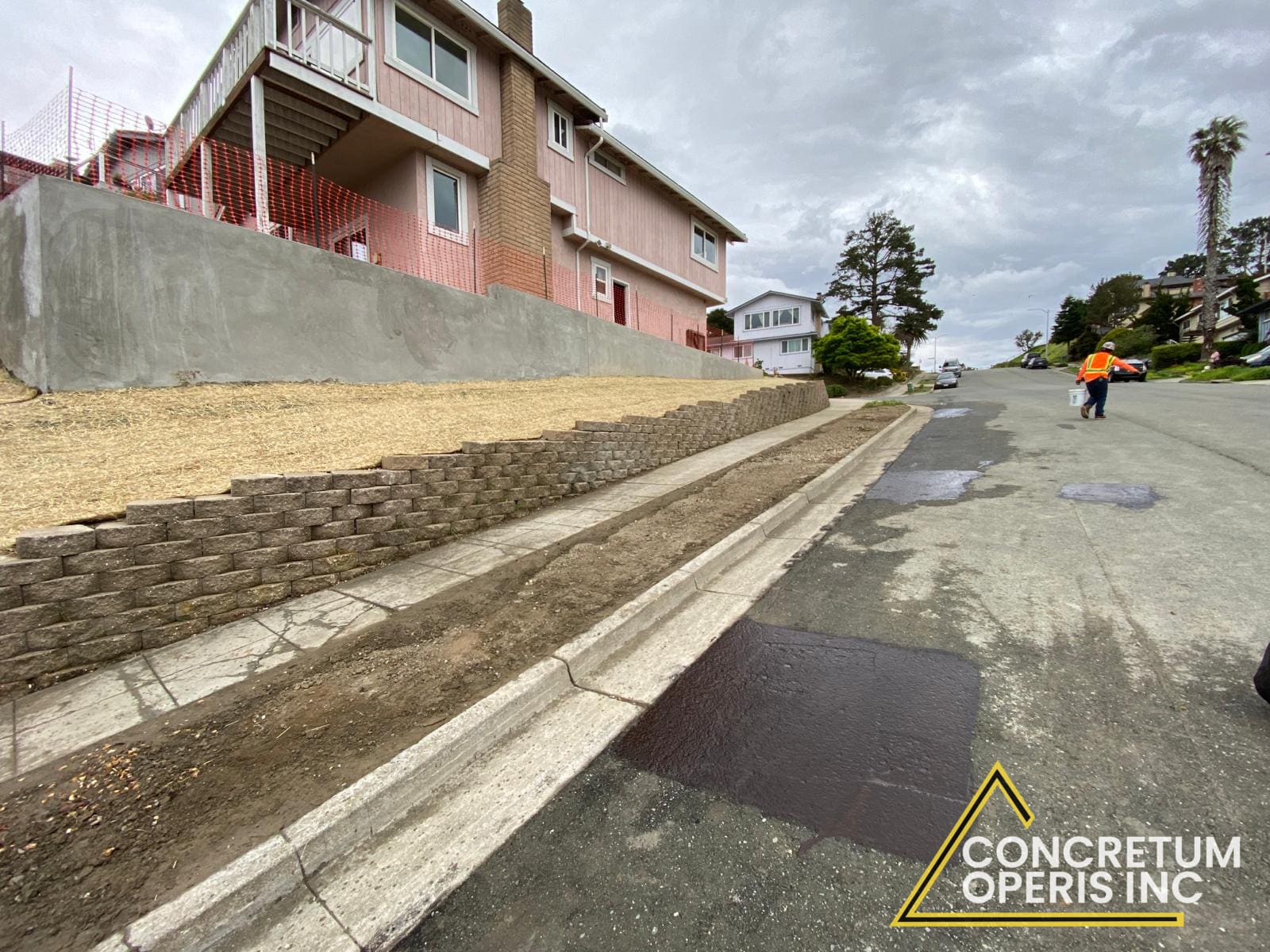 Poured concrete retaining wall and new curb along a hillside street in Bonita, CA