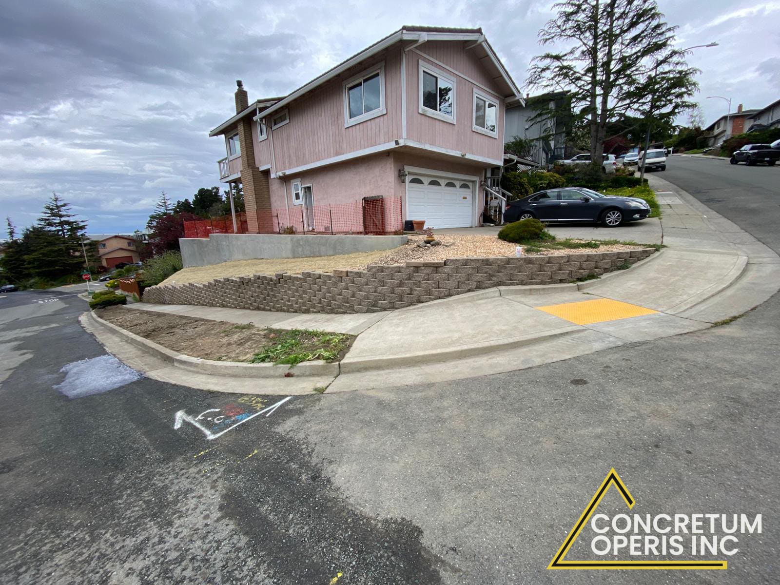 Crew pouring concrete into retaining wall formwork on a hillside in Bonita, CA