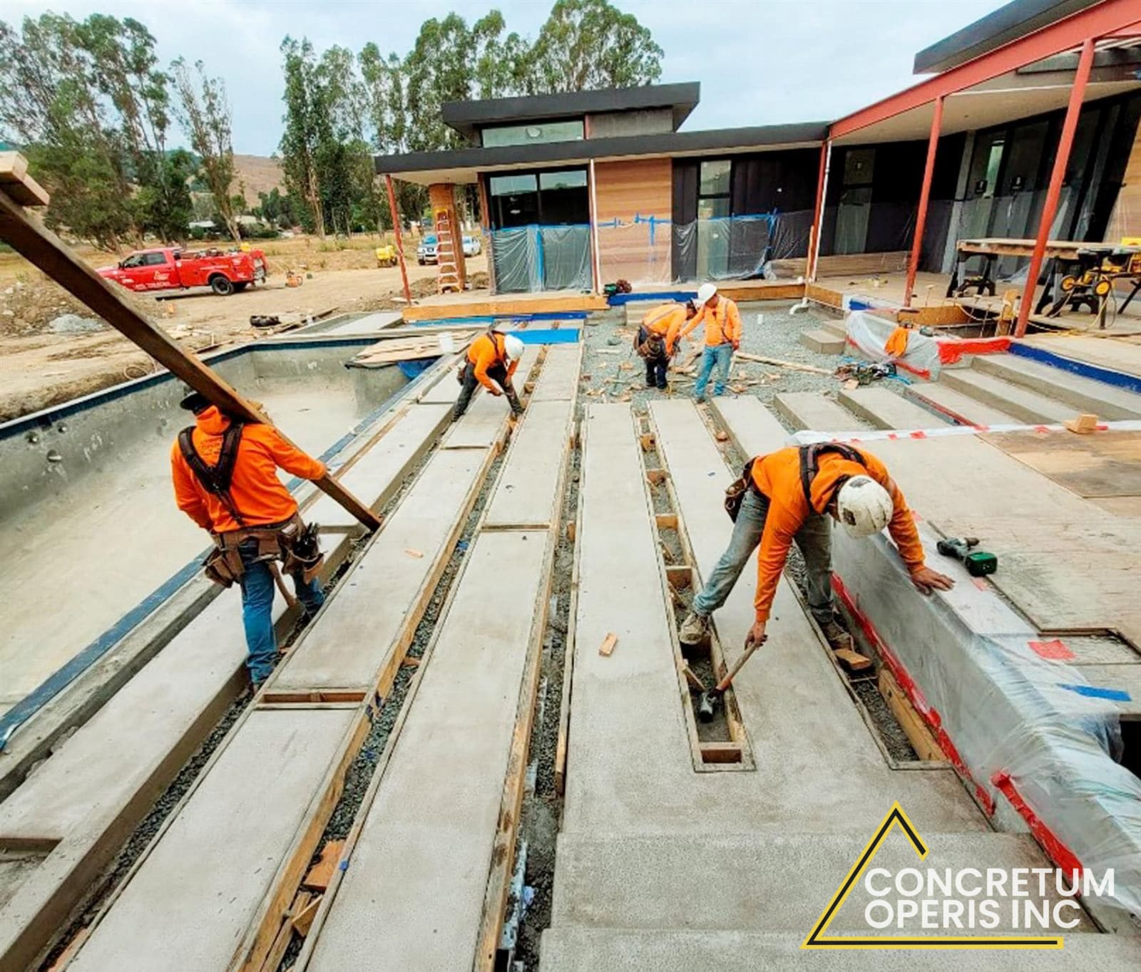 Crew forming and placing concrete deck slabs around a pool in Richmond, CA