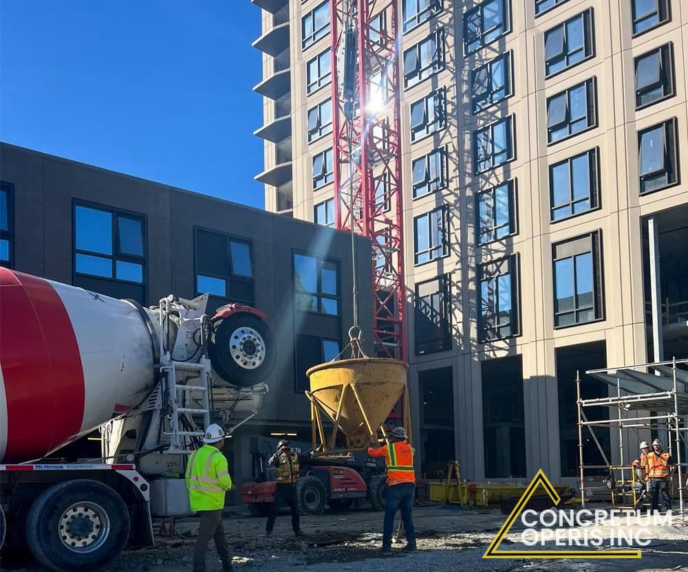 Crew placing pumped concrete into a rebar-reinforced rooftop pour in Richmond, CA