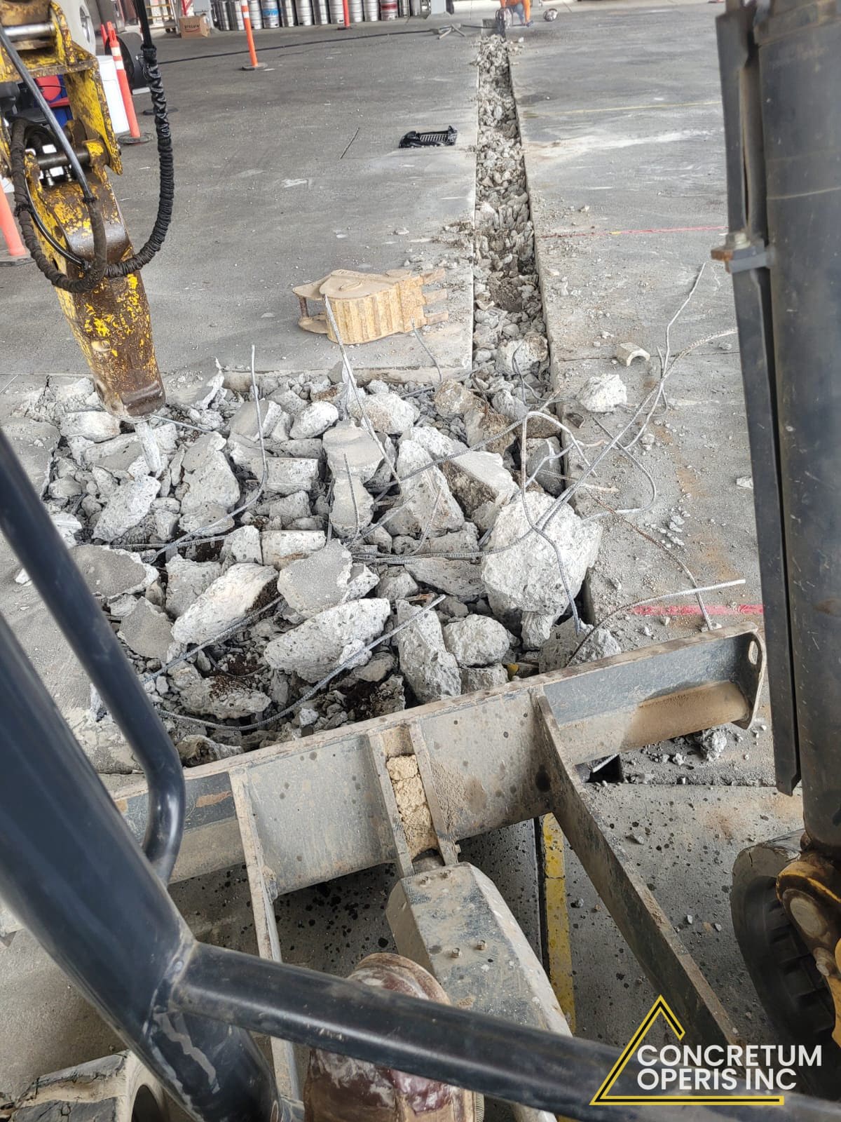 Hydraulic breaker cutting a trench in a concrete parking lot in Richmond, CA