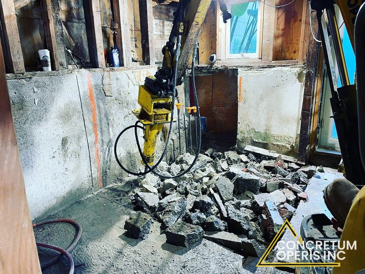 Interior demolition of concrete and framing inside a residential remodel in Richmond, CA
