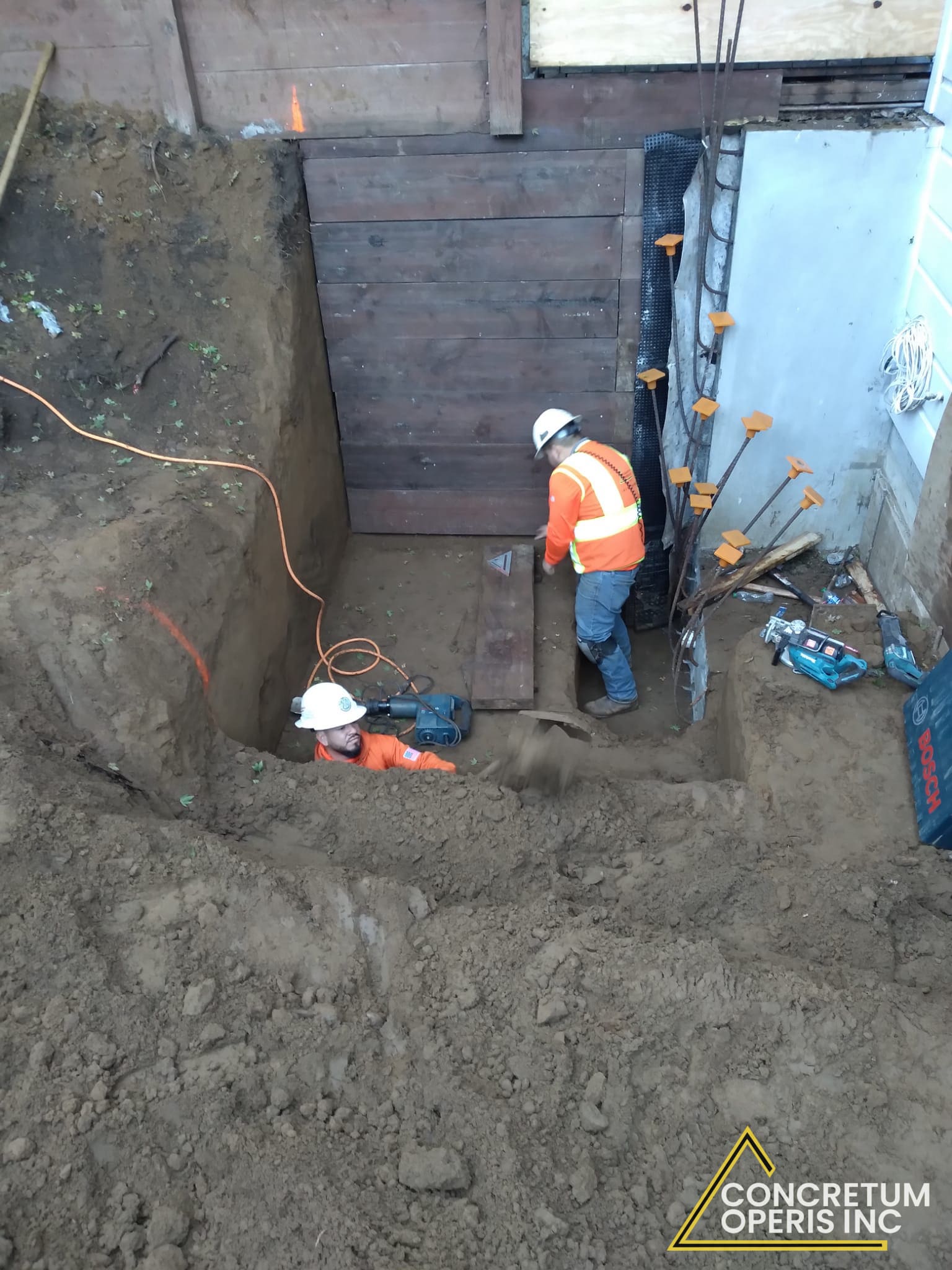 Crew excavating beneath a house foundation for a seismic retrofit in Richmond, CA