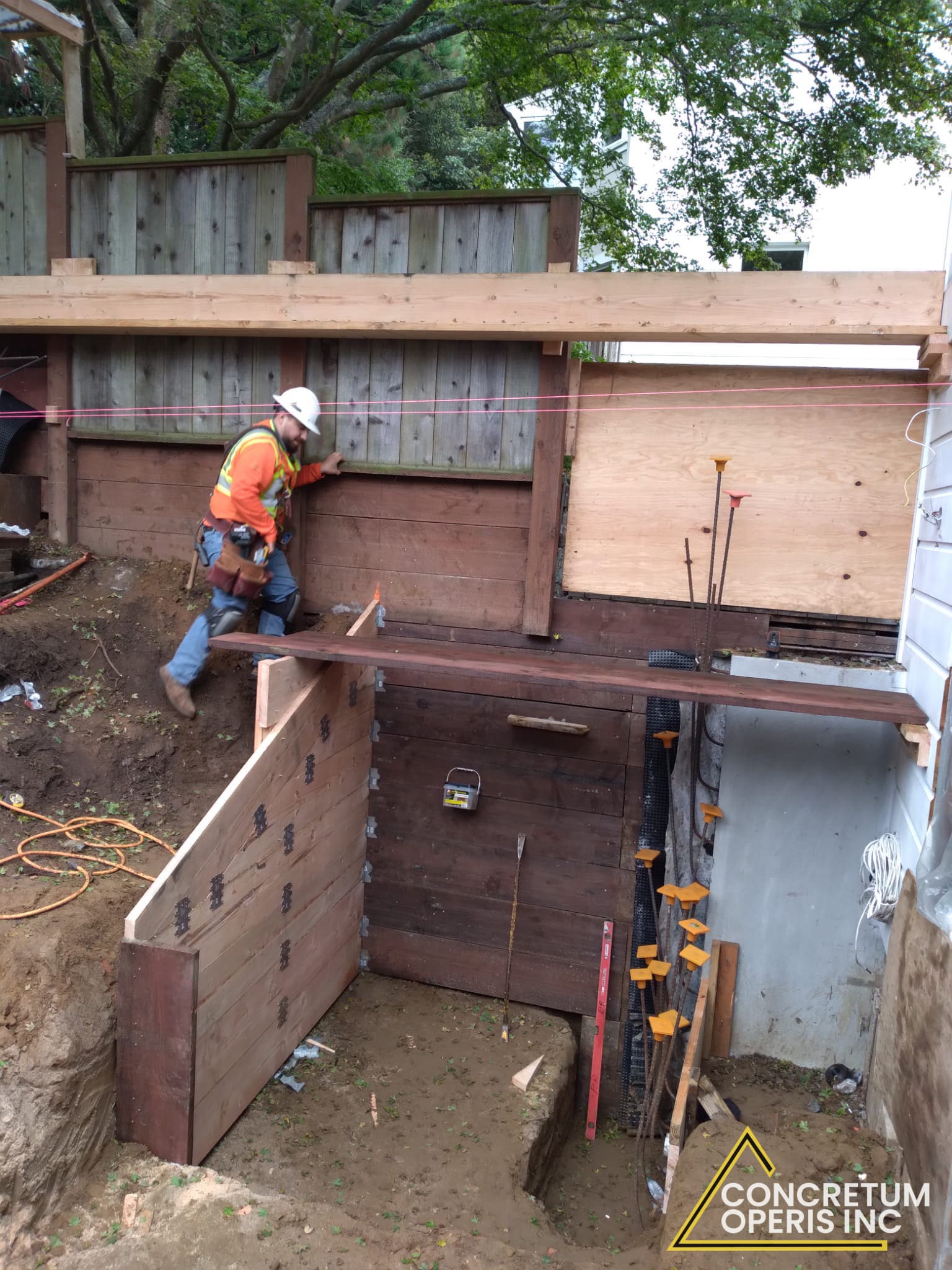 Seismic retrofit framing and bracing along a backyard foundation wall in Richmond, CA