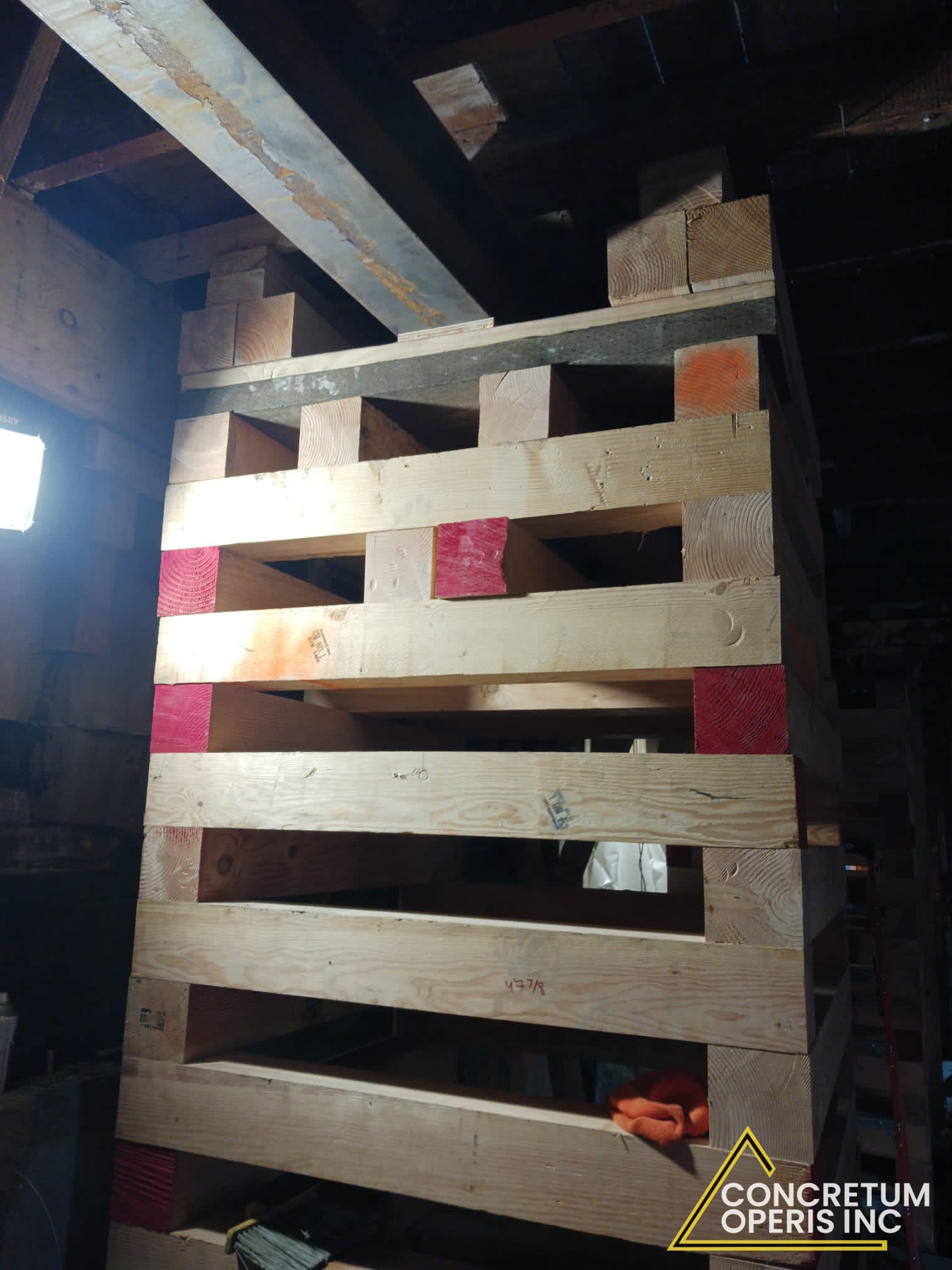 Timber cribbing tower shoring up floor framing during foundation work in Richmond, CA