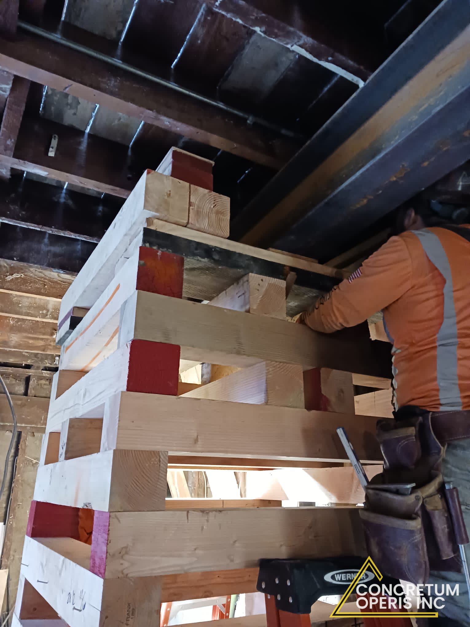 Crew shoring floor joists with timber cribbing in Richmond, CA