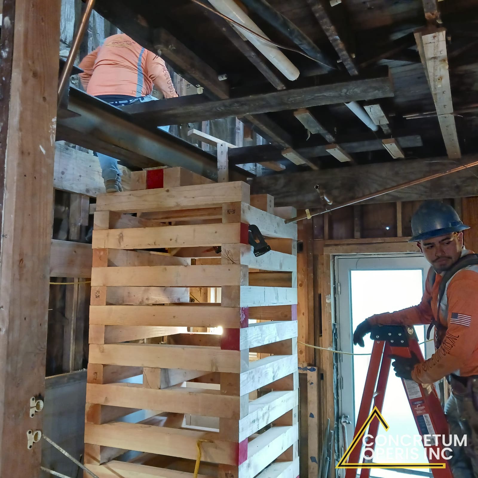 Crew shoring floor framing with a timber cribbing tower in Richmond, CA