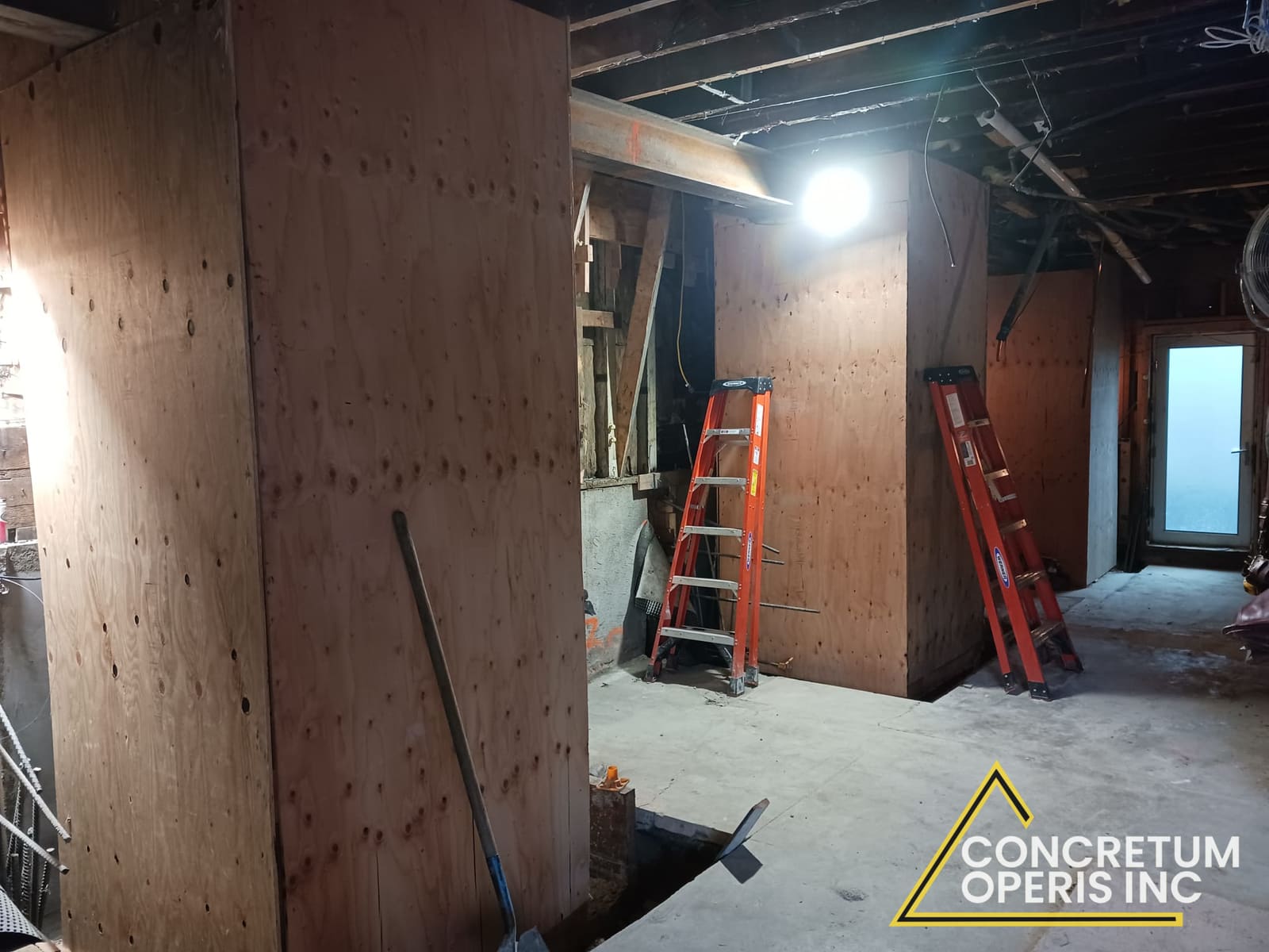Plywood shoring boxes braced with ladders inside a foundation excavation in Richmond, CA