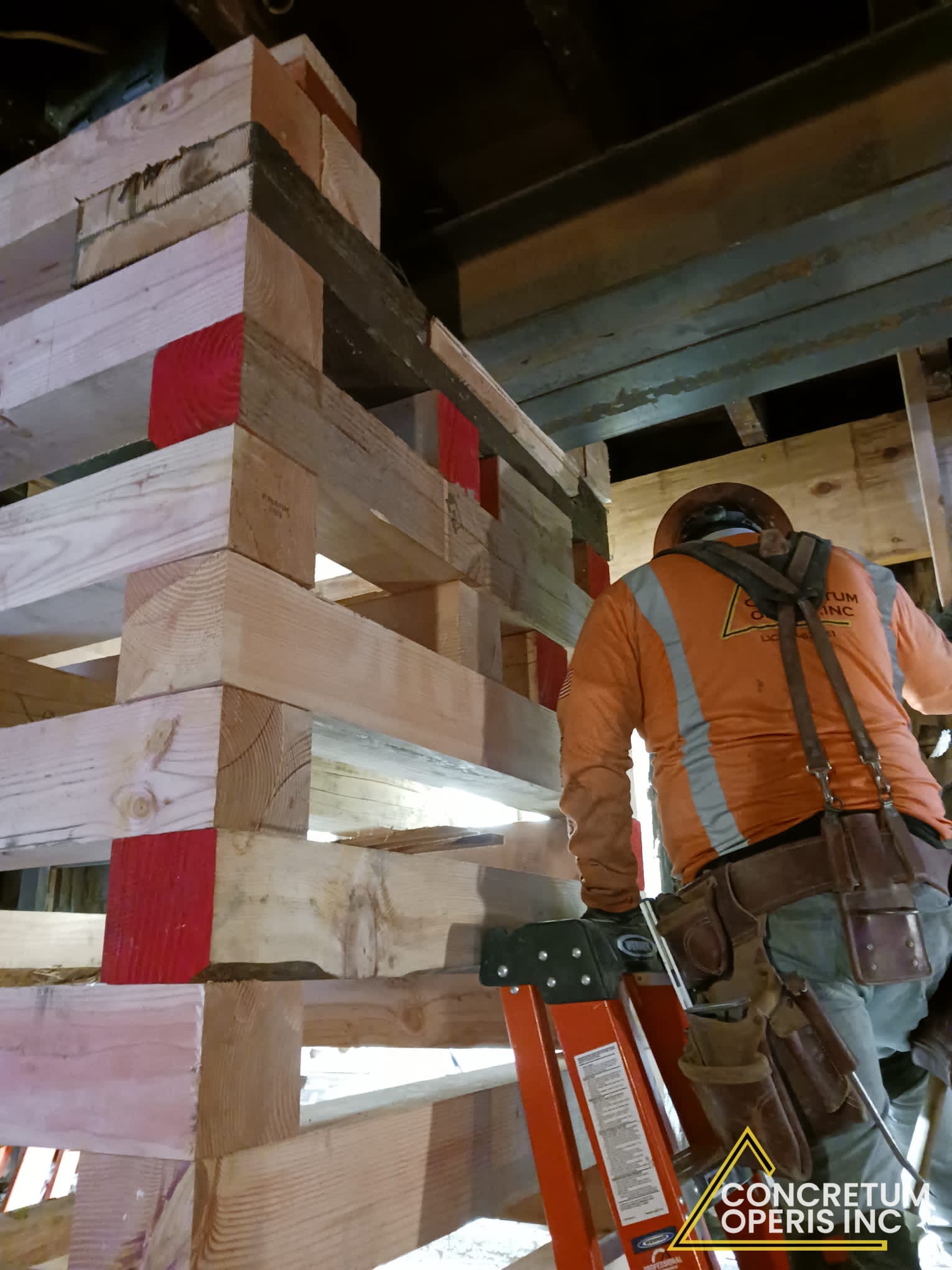 Crew building a timber cribbing tower to shore floor framing in Richmond, CA