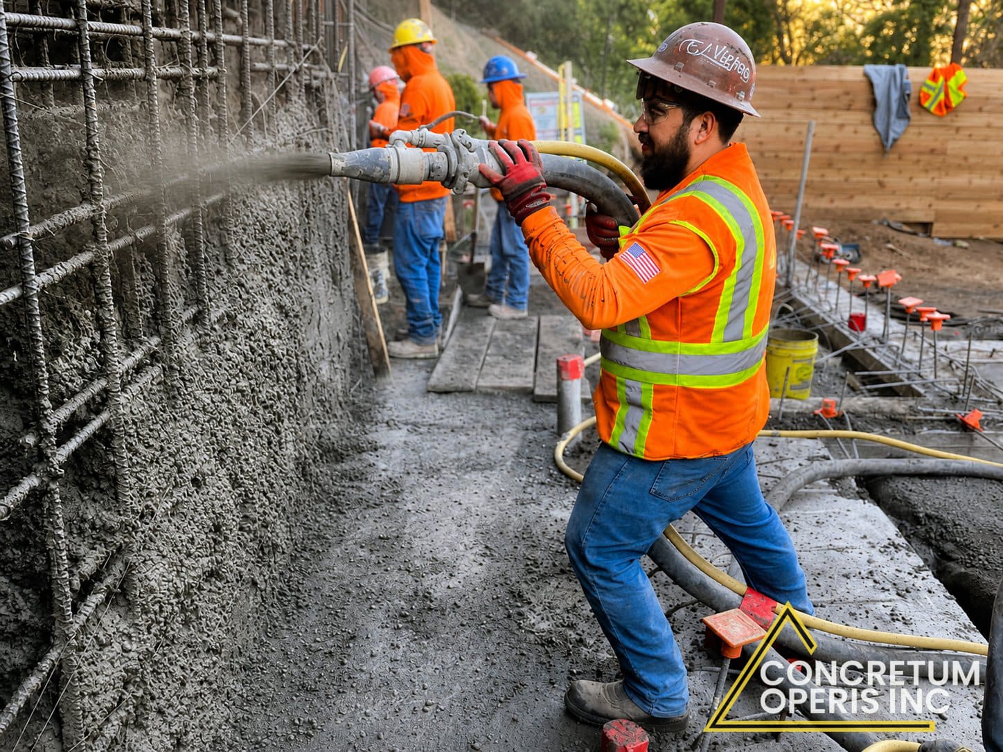 Worker applying shotcrete to a rebar-reinforced wall in Richmond, CA