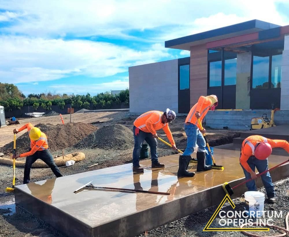 Crew finishing a freshly poured concrete slab outside a home in Richmond, CA