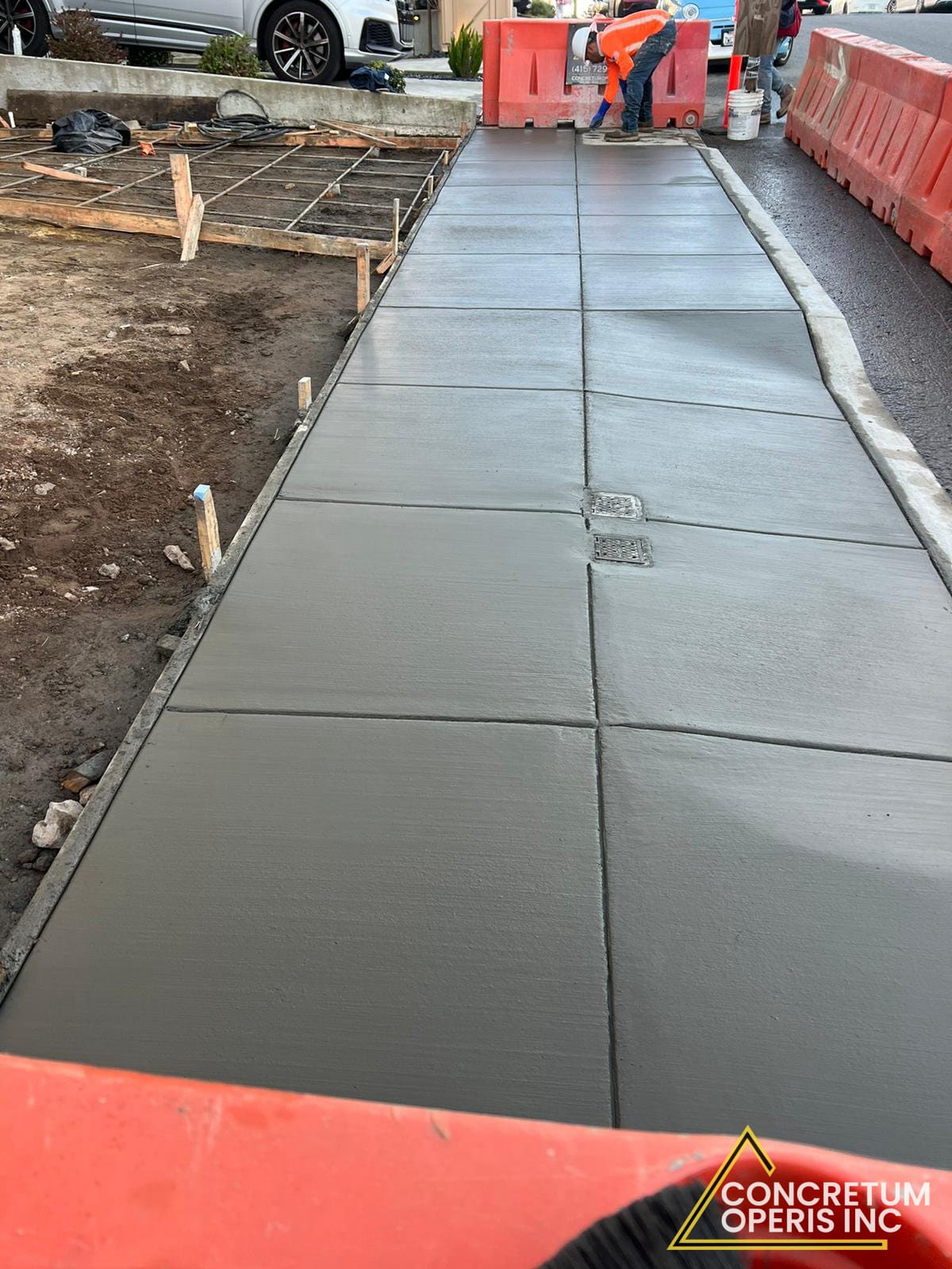 Freshly poured concrete sidewalk panels next to a residential curb in Richmond, CA