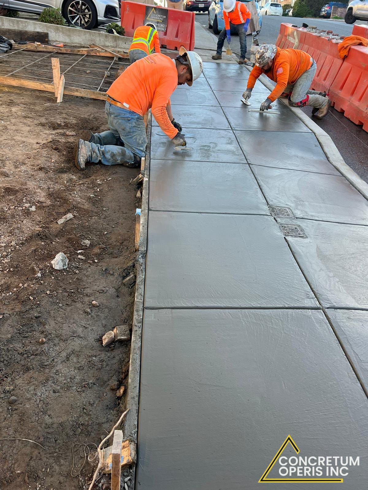 Crew finishing a freshly poured concrete sidewalk in Richmond, CA