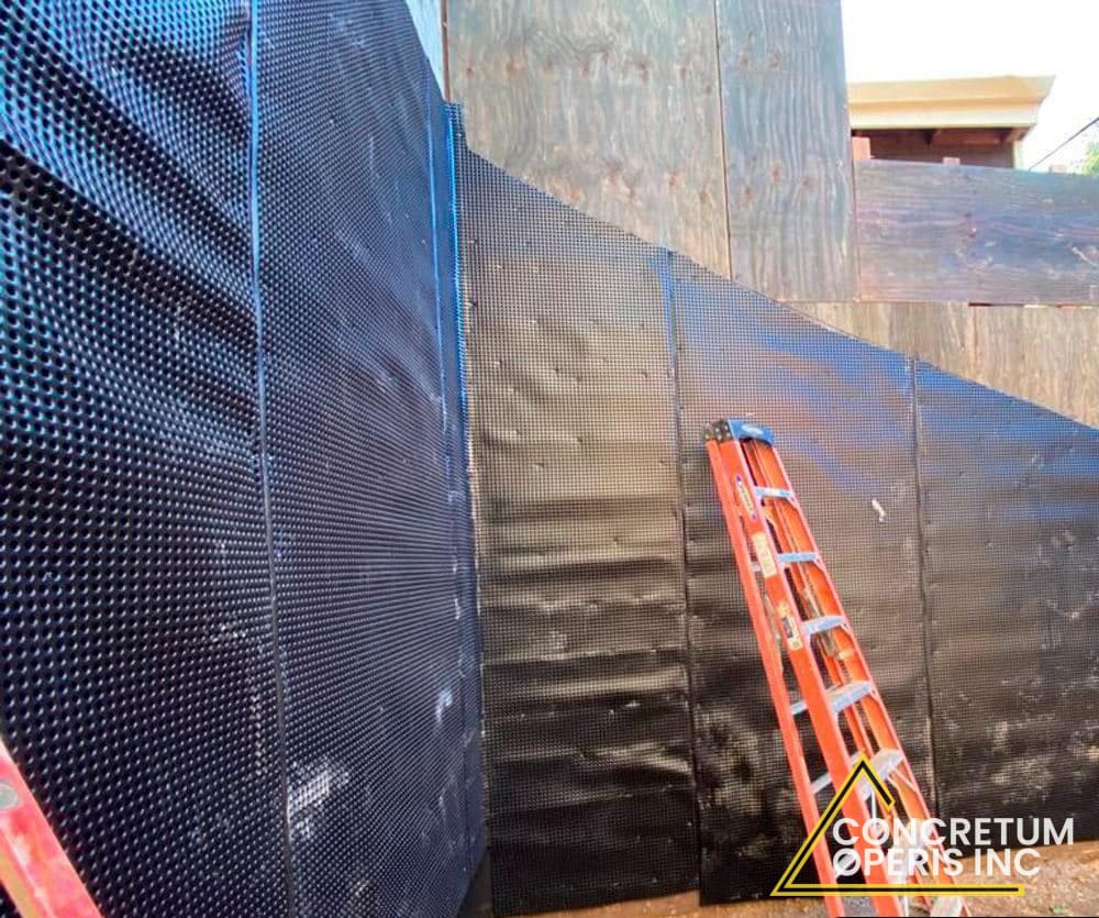 Dimpled waterproofing membrane panels installed along a foundation wall in Richmond, CA